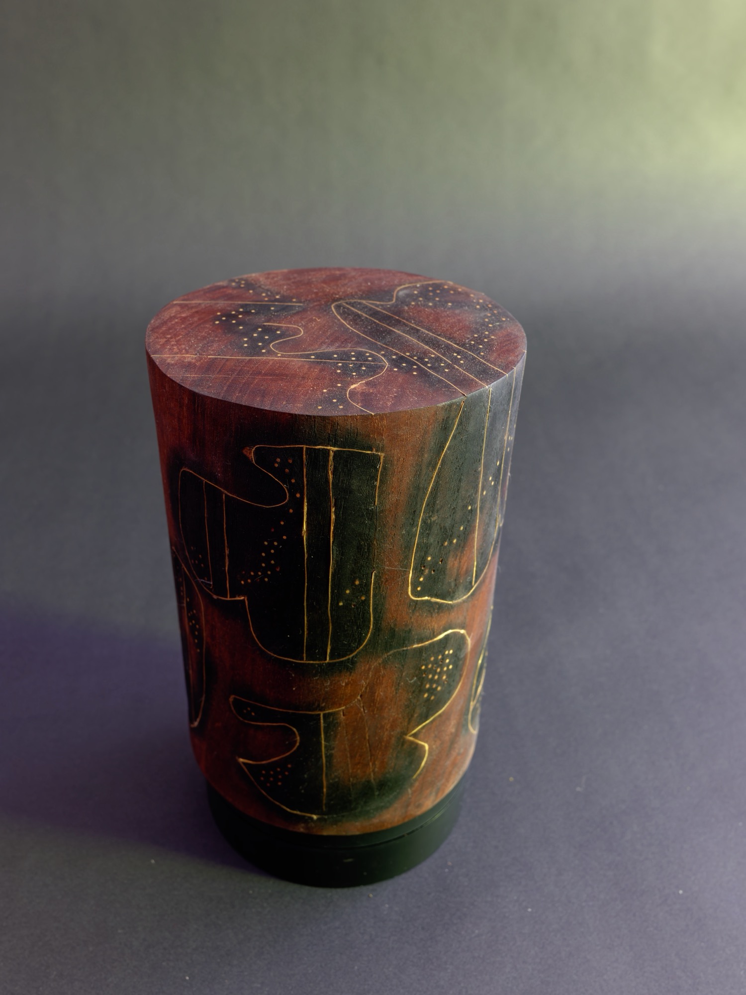Dream — near view of the etched line-work rising to the carved top face.
